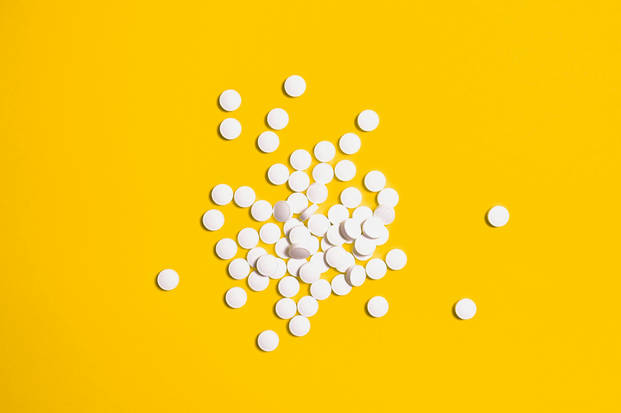 Yellow Background and White Round Pills